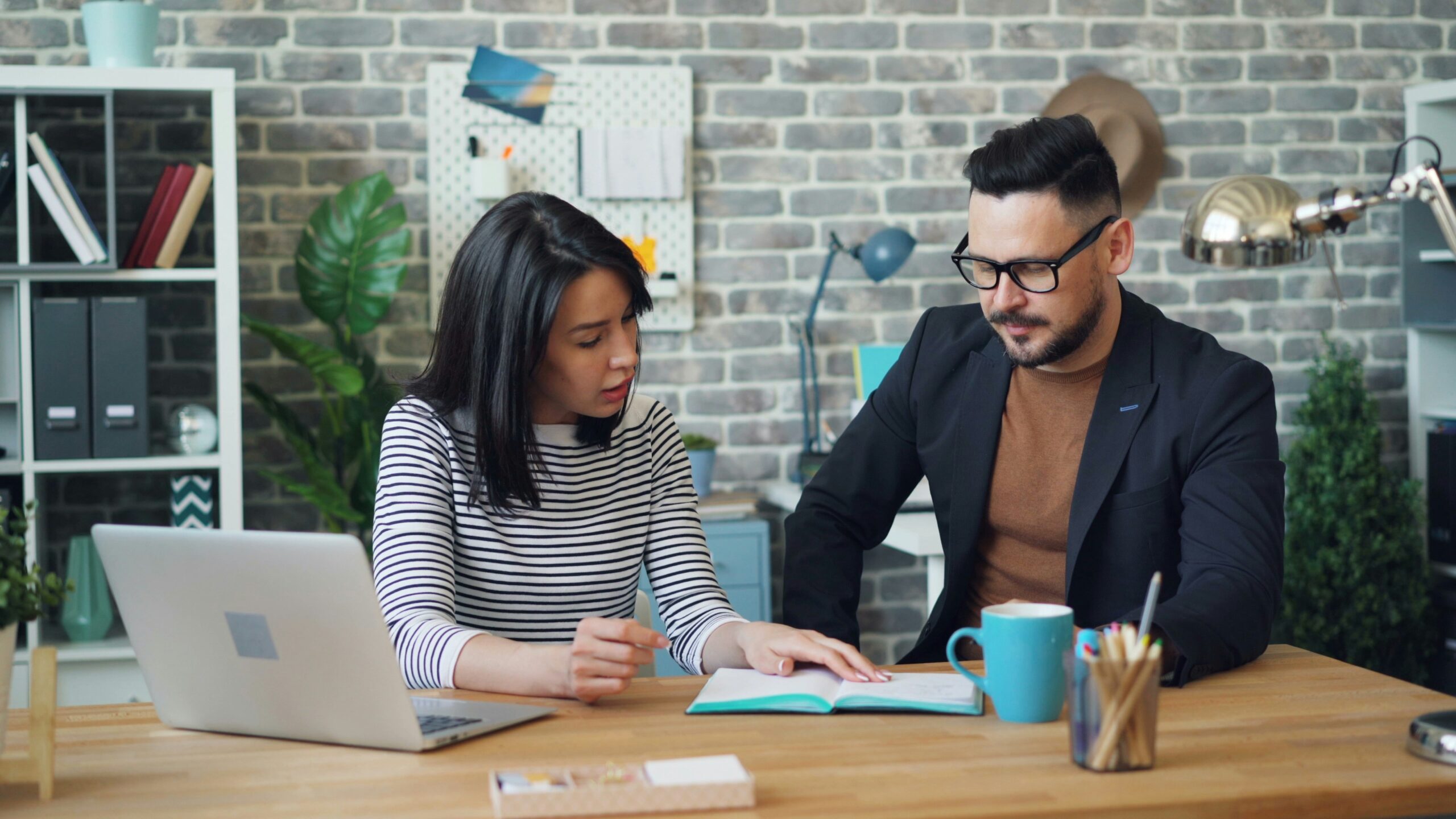 Two people reviewing material